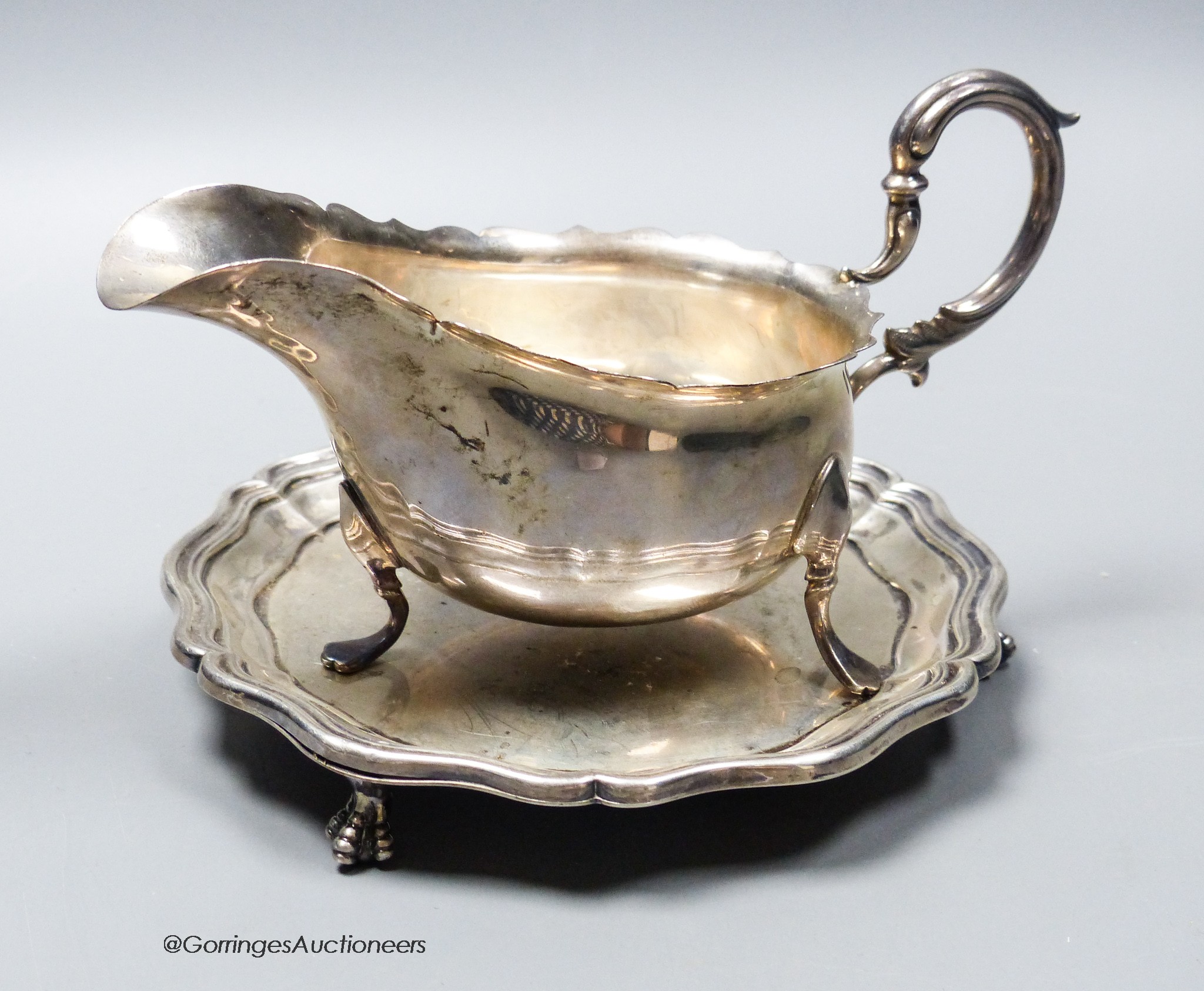 An Edwardian silver small waiter, 14.7cm, Sheffield, 1901 and a later silver sauceboat, 10.5oz.